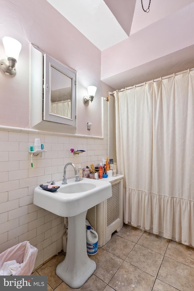 bathroom featuring tile patterned floors and tile walls