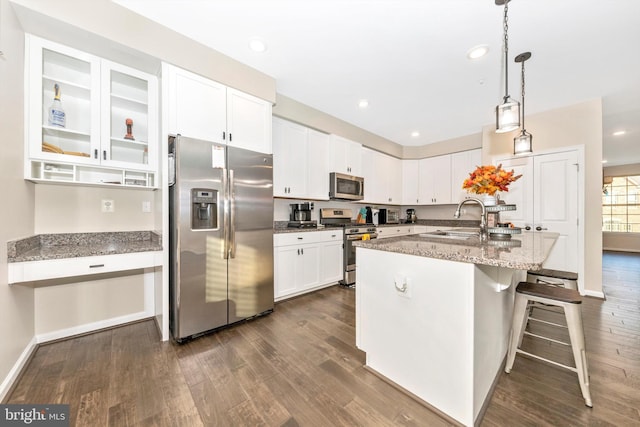 kitchen featuring sink, appliances with stainless steel finishes, light stone counters, and dark hardwood / wood-style flooring