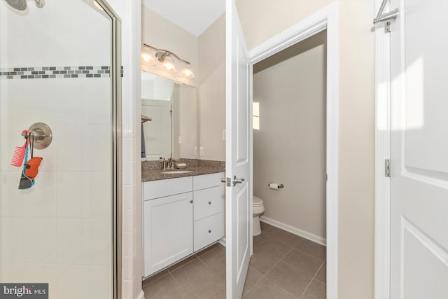 bathroom featuring vanity, toilet, tile patterned floors, and a shower with door