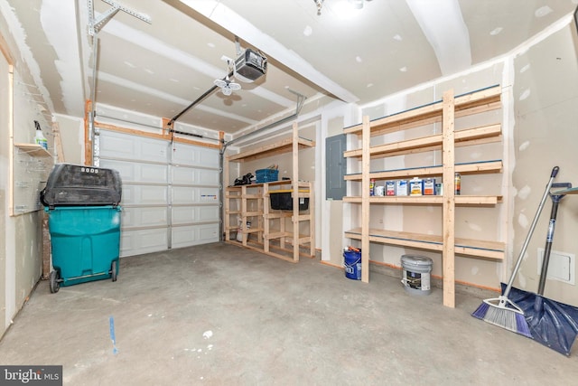 garage with a garage door opener and electric panel