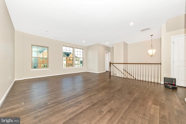 spare room with dark wood-type flooring