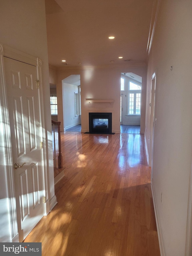 hall with crown molding and hardwood / wood-style flooring