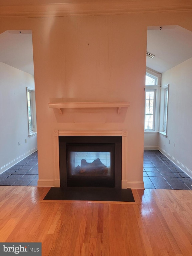 interior details with a multi sided fireplace and hardwood / wood-style flooring