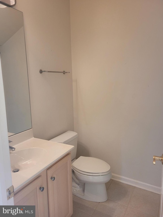 bathroom featuring vanity, toilet, and tile patterned flooring