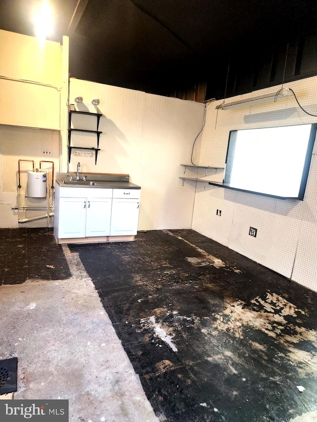 kitchen featuring white cabinets and sink