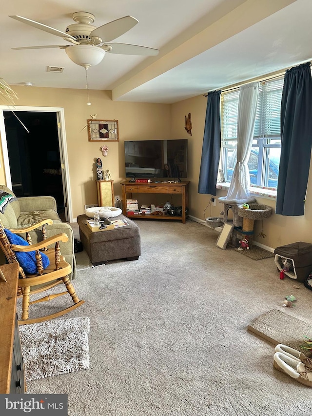 carpeted living room featuring ceiling fan