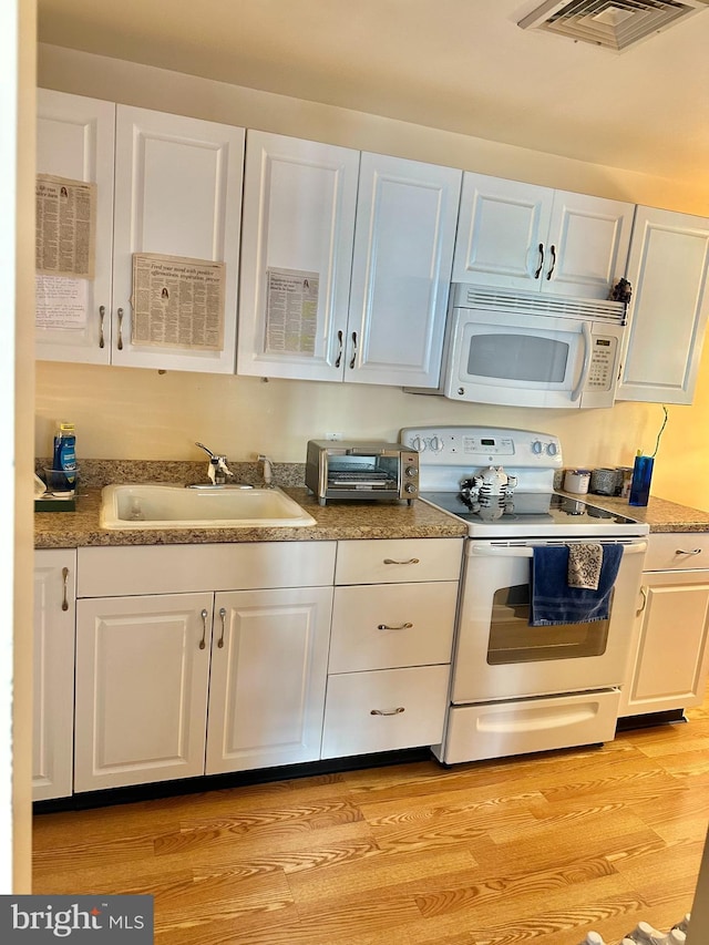 230 Holmes Rd, Holmes, PA 19043 - kitchen featuring a sink, white appliances, visible vents, a toaster, and white cabinetry