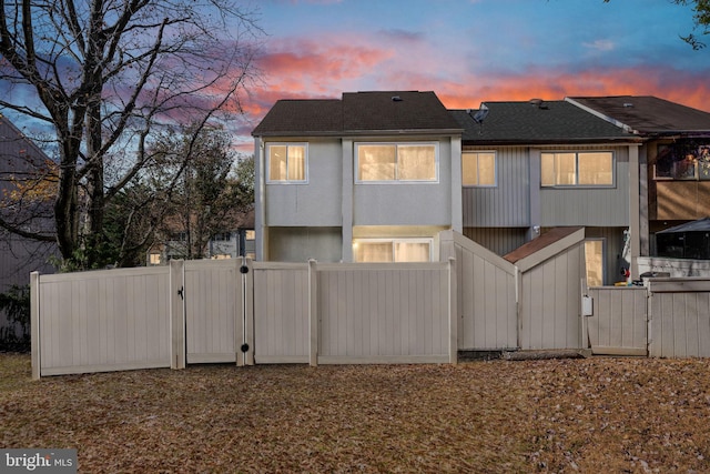 view of back house at dusk