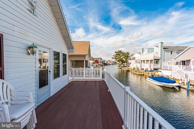 deck with a water view and a boat dock