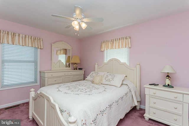 bedroom with ceiling fan and dark carpet