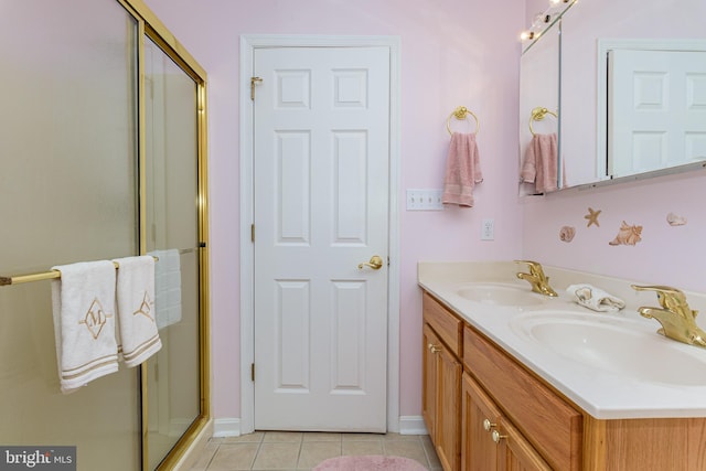 bathroom with vanity, tile patterned floors, and a shower with door