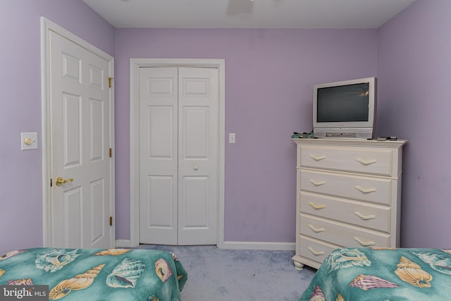 bedroom with light colored carpet and a closet