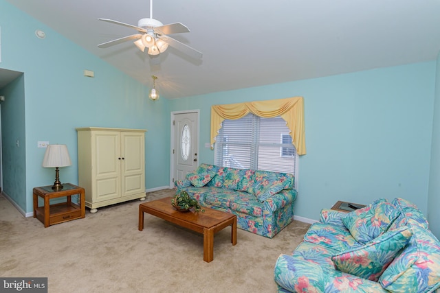 carpeted living room with ceiling fan and vaulted ceiling