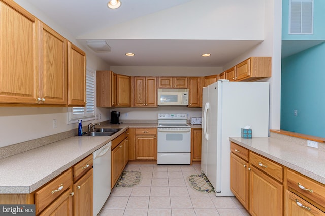 kitchen with light tile patterned floors, white appliances, and sink