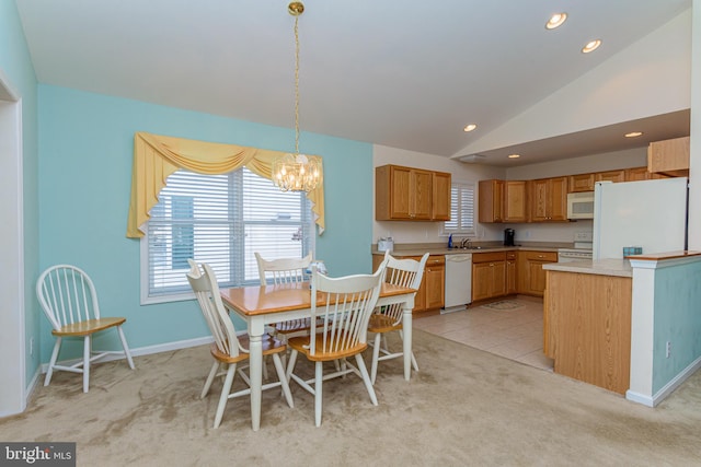 kitchen featuring light colored carpet, white appliances, and lofted ceiling