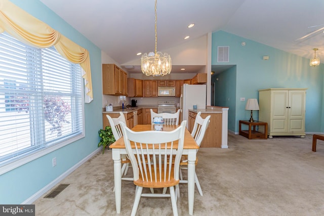 carpeted dining room with a chandelier and vaulted ceiling