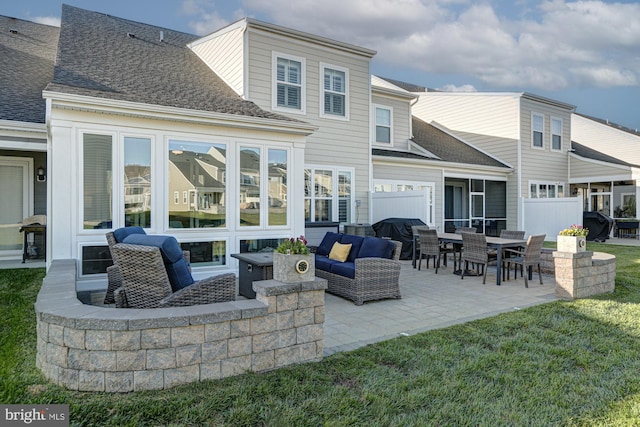 back of house with a patio and a yard