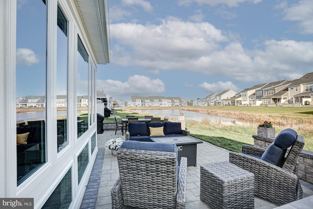 view of patio with a water view and an outdoor hangout area