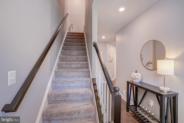 staircase with wood-type flooring