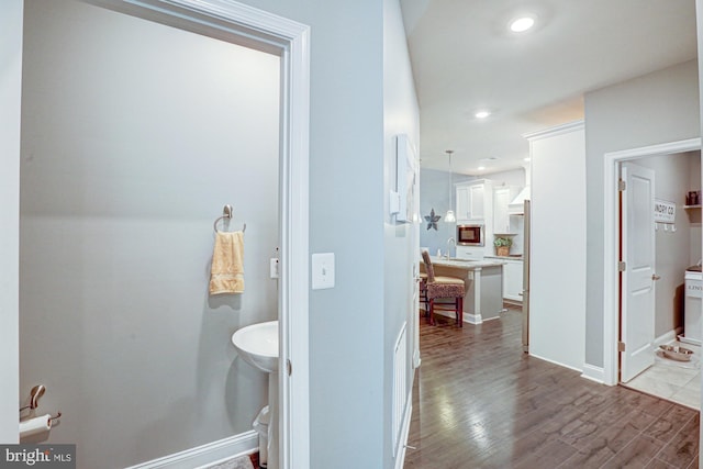 bathroom with sink and hardwood / wood-style flooring