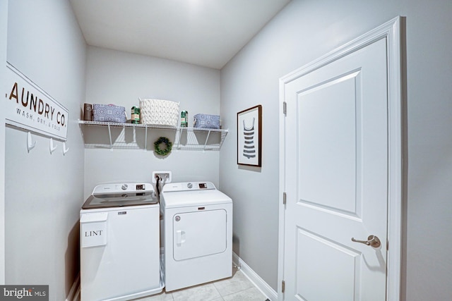 laundry room featuring independent washer and dryer and light tile patterned floors