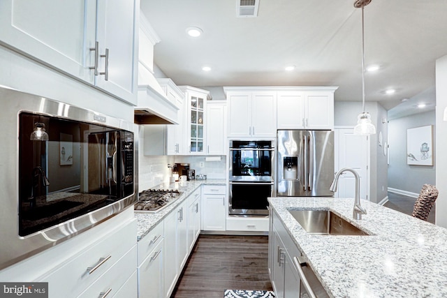 kitchen featuring appliances with stainless steel finishes, sink, and white cabinets