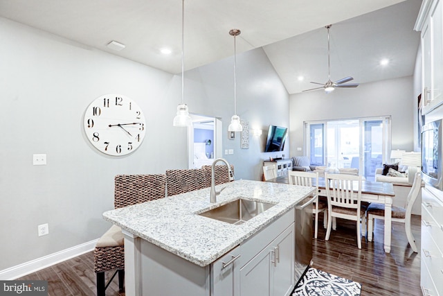 kitchen with dishwasher, sink, pendant lighting, white cabinets, and dark wood-type flooring