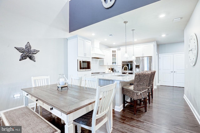 dining room with sink and dark hardwood / wood-style floors