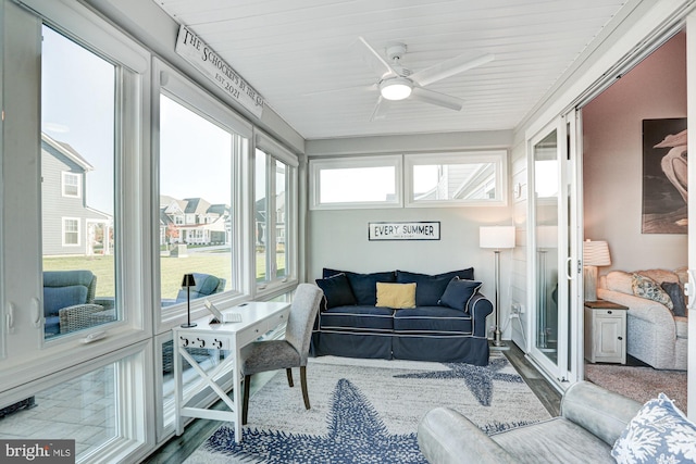 sunroom / solarium featuring a wealth of natural light, wooden ceiling, and ceiling fan