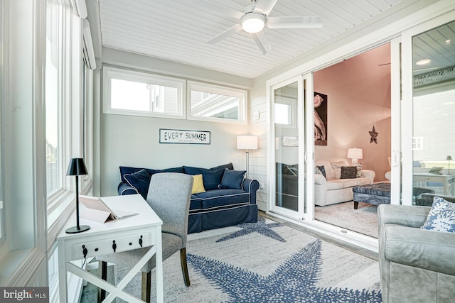 sunroom featuring wood ceiling and ceiling fan