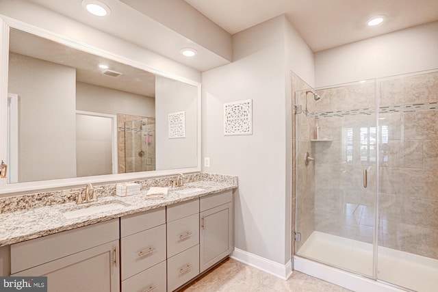 bathroom with vanity, an enclosed shower, and tile patterned flooring