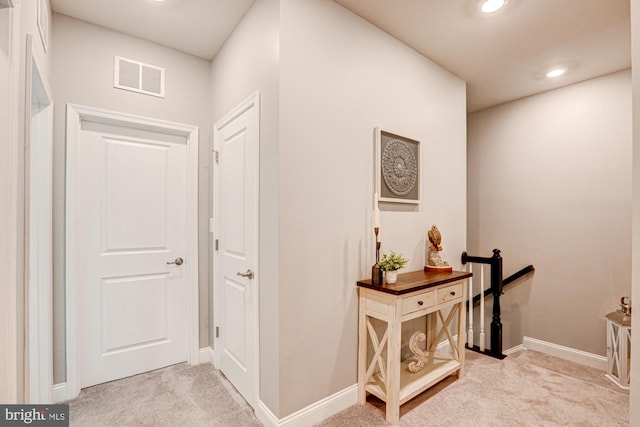 hallway with light colored carpet