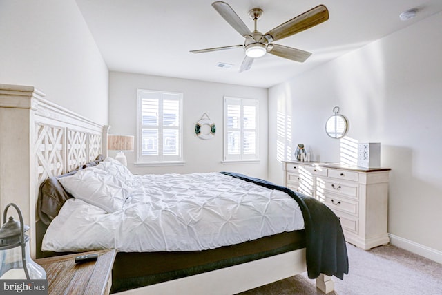 bedroom featuring light colored carpet and ceiling fan