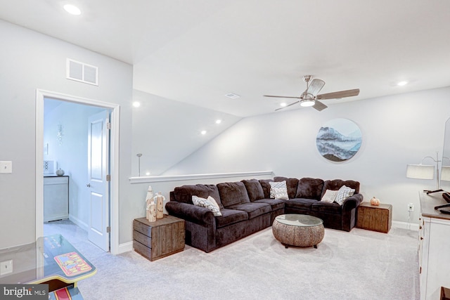 carpeted living room with ceiling fan and lofted ceiling