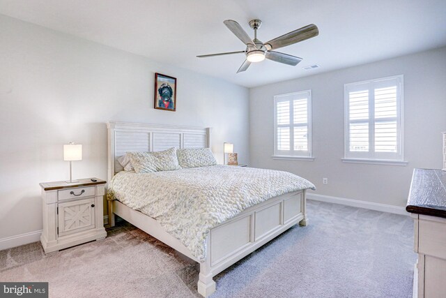 bedroom featuring ceiling fan and light colored carpet