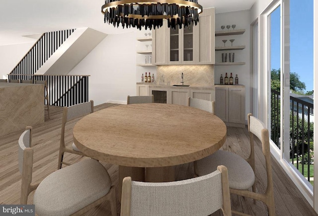 dining space with indoor wet bar and light hardwood / wood-style flooring