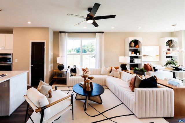 living room with light wood-type flooring and ceiling fan