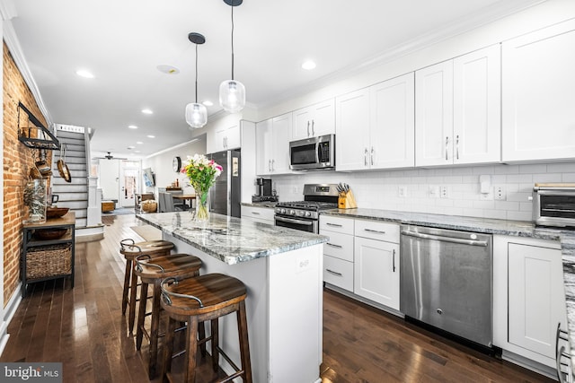 kitchen featuring white cabinets, dark hardwood / wood-style floors, and appliances with stainless steel finishes