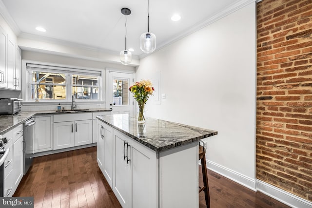 kitchen with dark hardwood / wood-style flooring, dark stone counters, sink, and white cabinets