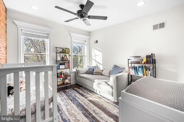 bedroom featuring dark hardwood / wood-style flooring and ceiling fan