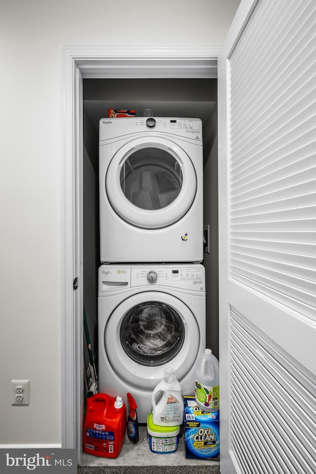 laundry room featuring stacked washer / dryer