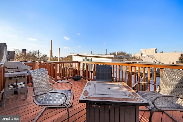 wooden deck with an outdoor fire pit