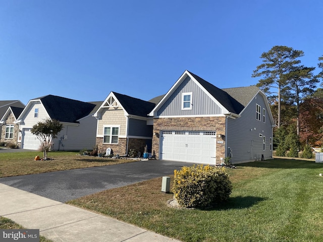 view of front of home with a front yard and a garage