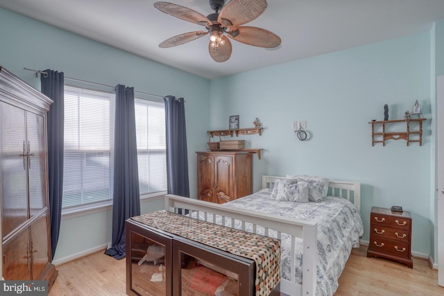 bedroom with light hardwood / wood-style floors and ceiling fan