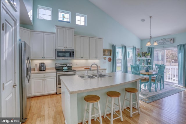 kitchen with pendant lighting, white cabinetry, appliances with stainless steel finishes, and sink