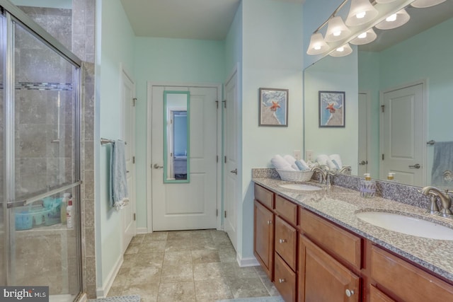 bathroom featuring an enclosed shower, vanity, and tile patterned flooring