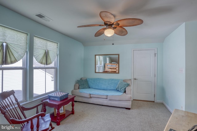 carpeted living room featuring ceiling fan