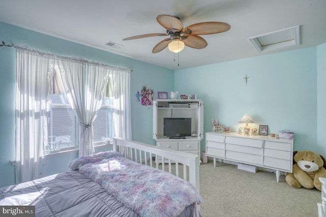 bedroom with ceiling fan, multiple windows, and light carpet