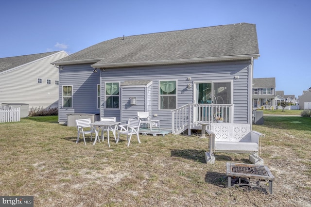 back of house with a lawn