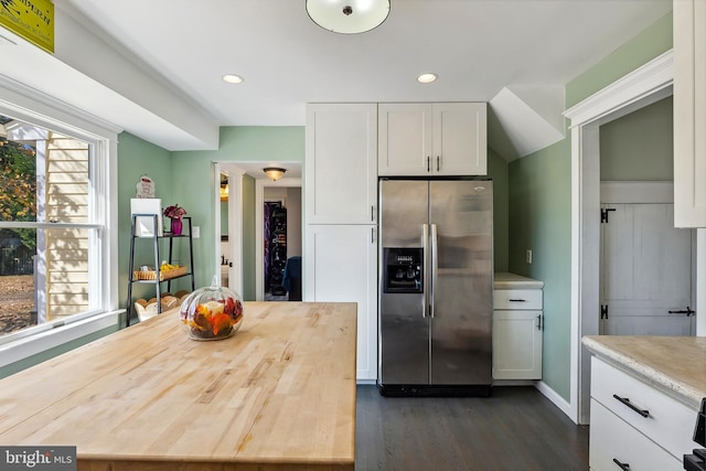 kitchen featuring white cabinets, butcher block countertops, dark hardwood / wood-style flooring, and stainless steel refrigerator with ice dispenser